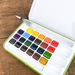La boîte aquarelle et pinceau réservoir d'eau